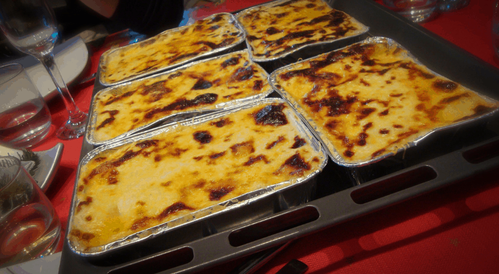 a few trays of canalones on the Christmas table with a red table cloth