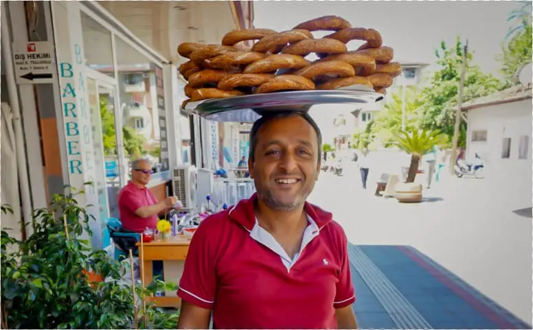 A Man With A Red Shirt In The Streets Of Fethiye Turkey Carrying Carrying Simit On His Head