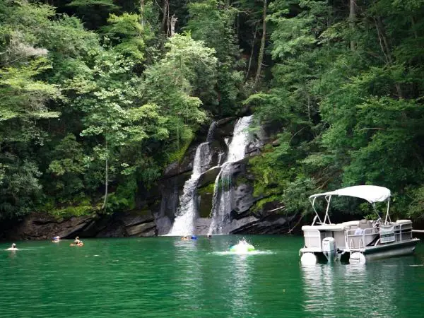 Lake Jocassee waterfall and boat on the water in south carolina