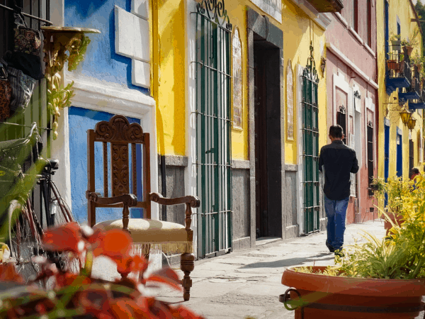 A man walking down Calle 6 Sur, or Los Sapos, in Puebla, Mexico